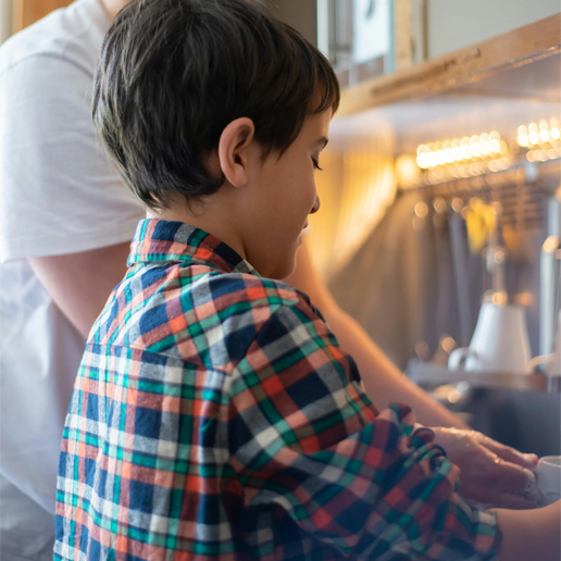 Child doing dishes as a household chore
